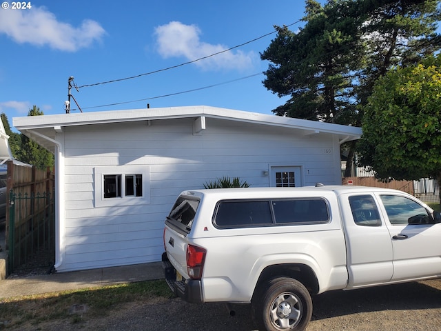 view of home's exterior featuring fence