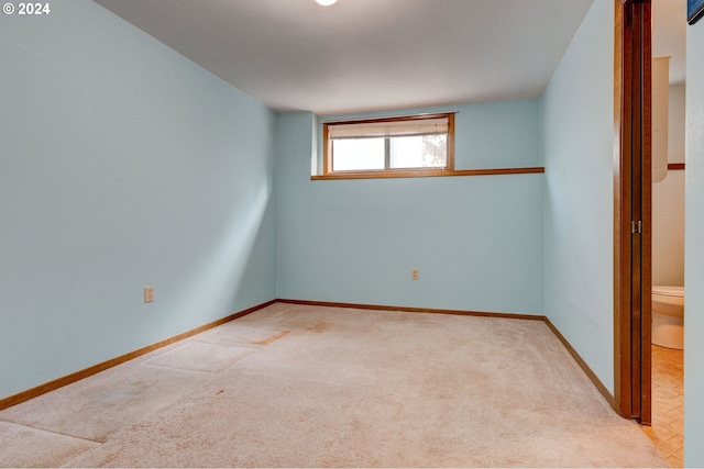 spare room featuring light colored carpet