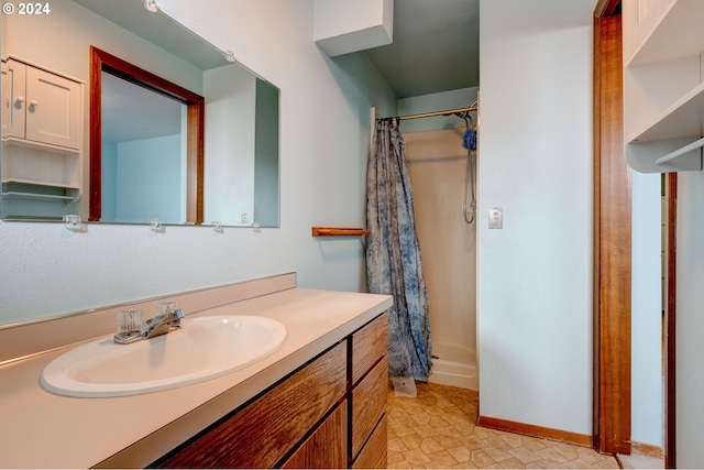 bathroom featuring vanity, walk in shower, and tile patterned flooring