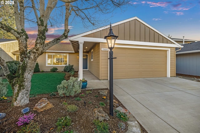 view of front of property featuring a garage and a lawn