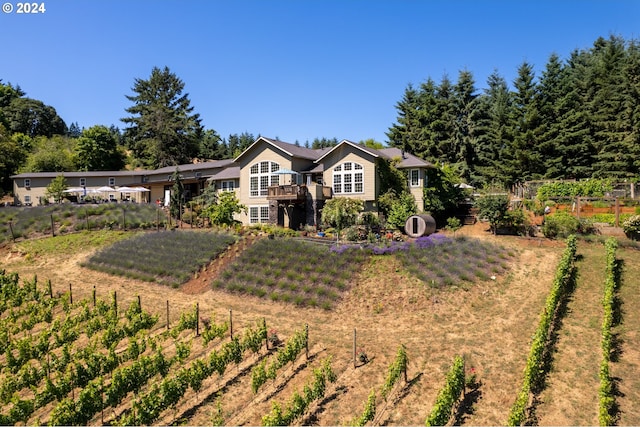 view of front of house featuring a rural view and a front lawn