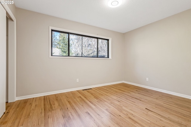 unfurnished bedroom with a closet and light hardwood / wood-style flooring