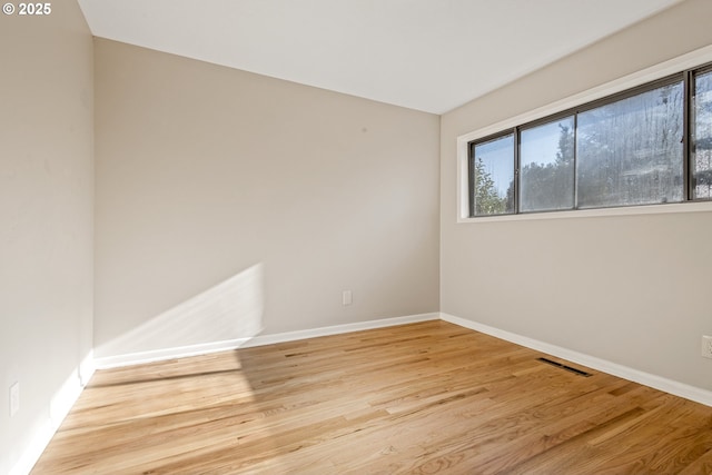 empty room with light hardwood / wood-style flooring