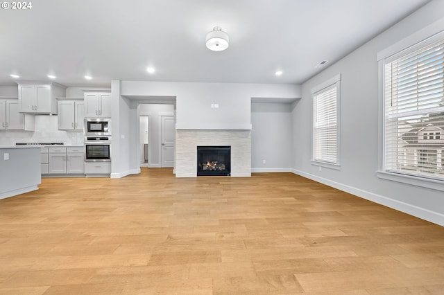 unfurnished living room with light hardwood / wood-style floors