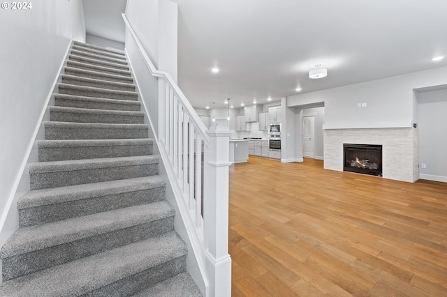 stairway featuring wood-type flooring