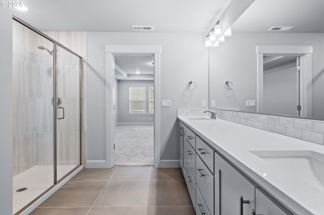 bathroom featuring vanity, tile patterned flooring, and walk in shower