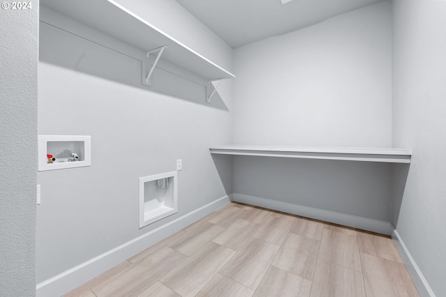 laundry room featuring hookup for a washing machine and light hardwood / wood-style flooring