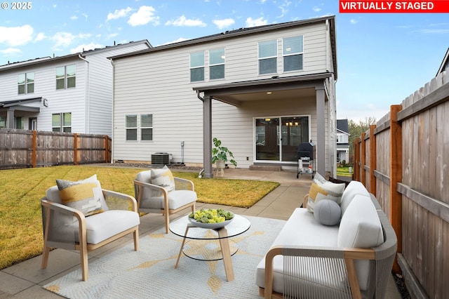 rear view of house with cooling unit, a yard, an outdoor living space, and a patio