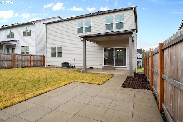 rear view of property with a yard and a patio