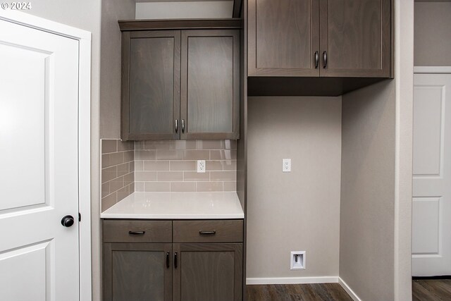 kitchen with dark brown cabinets, backsplash, and dark hardwood / wood-style floors