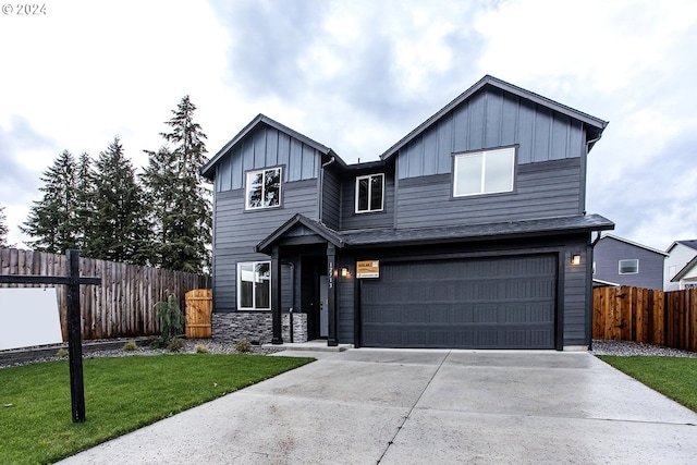 view of front facade with a front yard and a garage