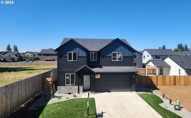 view of front of property with a garage and a front lawn