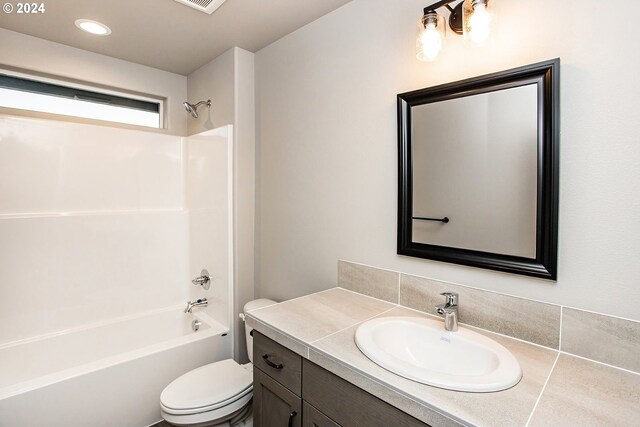 full bathroom featuring vanity,  shower combination, and toilet