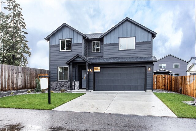 view of front of property with a garage and a front lawn