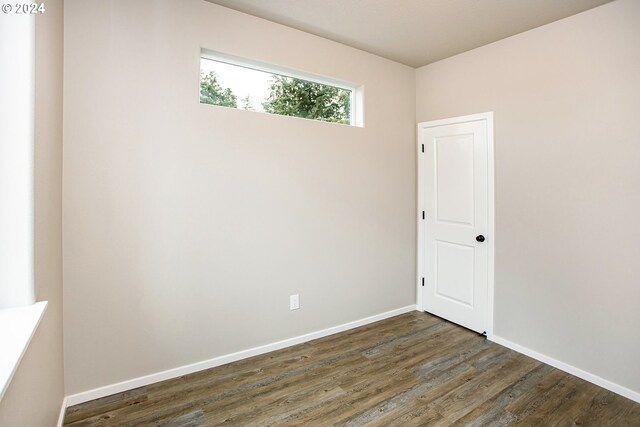 spare room with dark hardwood / wood-style floors