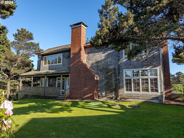 rear view of property with a lawn