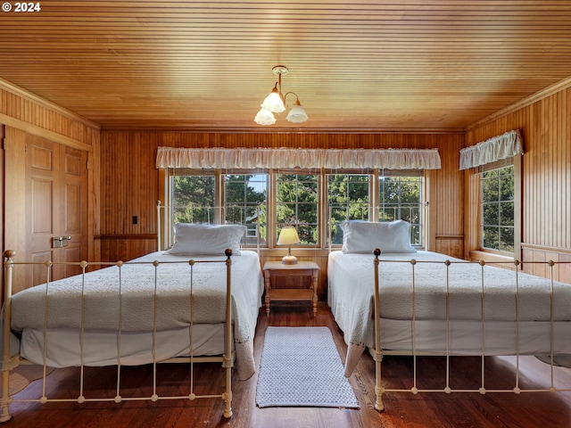 bedroom with hardwood / wood-style floors and multiple windows