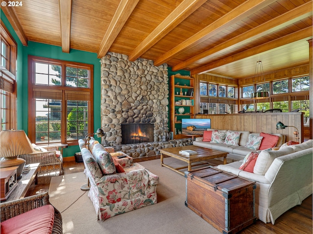 living room with wooden ceiling, beamed ceiling, and a fireplace