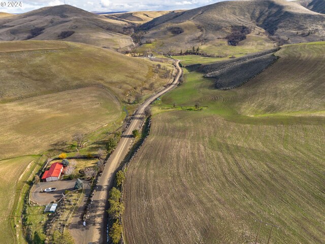 birds eye view of property with a mountain view and a rural view