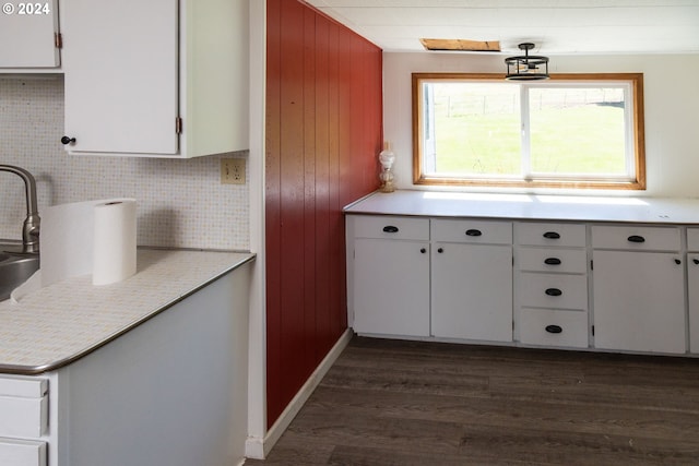 kitchen featuring white cabinets, dark hardwood / wood-style floors, and tasteful backsplash