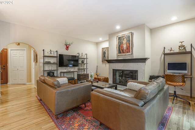 living room with light wood-type flooring and a fireplace