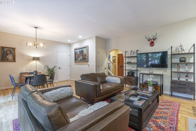 living room featuring light hardwood / wood-style flooring and a notable chandelier