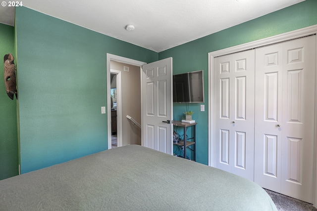 carpeted bedroom with a closet