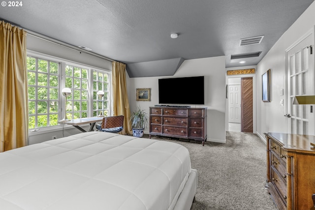 carpeted bedroom featuring a textured ceiling