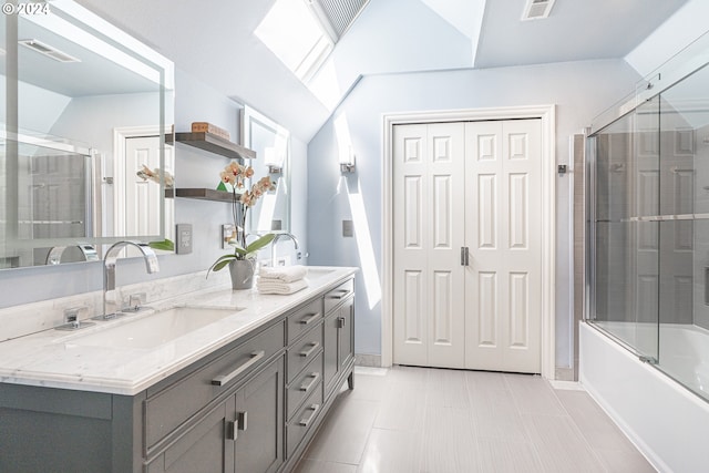 bathroom featuring tile patterned floors, lofted ceiling with skylight, vanity, and combined bath / shower with glass door