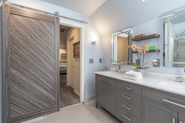 bathroom with tile patterned flooring, vanity, and vaulted ceiling