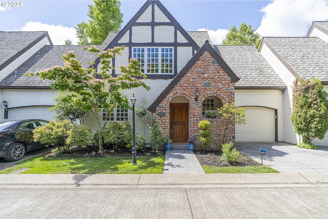 tudor-style house featuring a garage