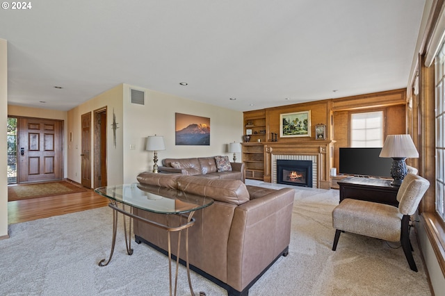 living room featuring a fireplace and light hardwood / wood-style flooring