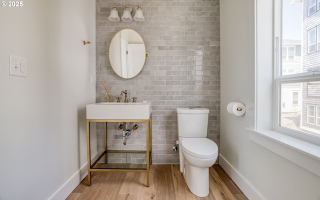 bathroom with sink, toilet, and wood-type flooring