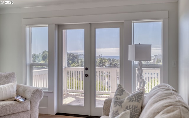 doorway to outside featuring ornamental molding