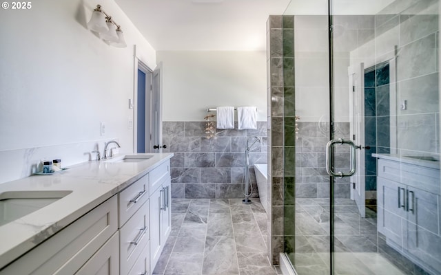 bathroom featuring tile walls, a shower with door, and vanity