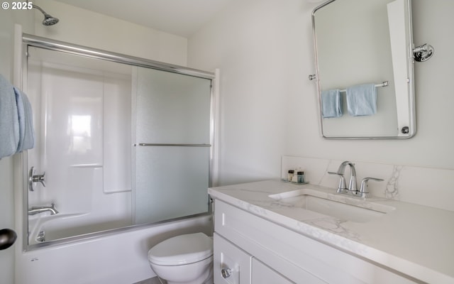 full bathroom featuring vanity, shower / bath combination with glass door, and toilet