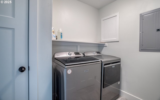 washroom with electric panel, cabinets, tile patterned floors, and washing machine and clothes dryer