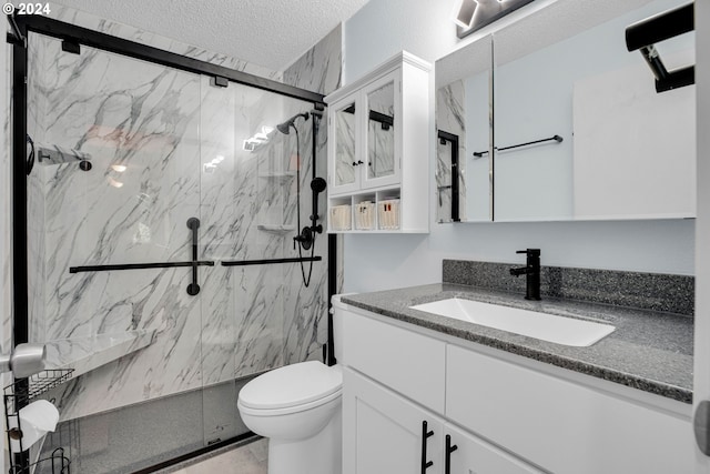 bathroom featuring toilet, an enclosed shower, vanity, and a textured ceiling