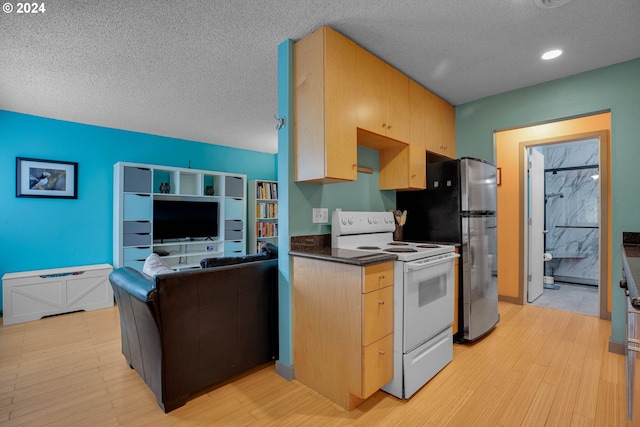 kitchen with stainless steel fridge, a textured ceiling, light hardwood / wood-style flooring, and white electric range oven