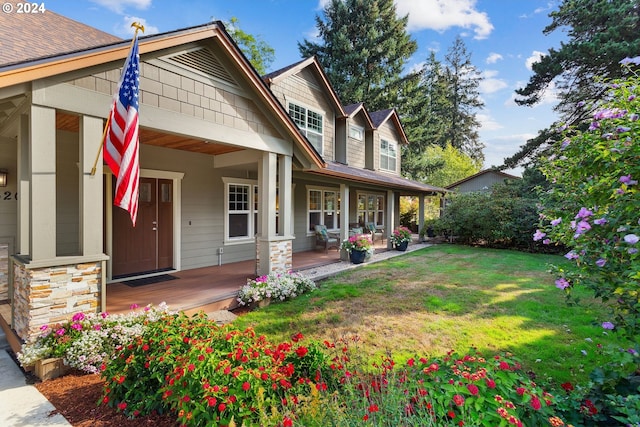 view of front of house with covered porch and a front yard