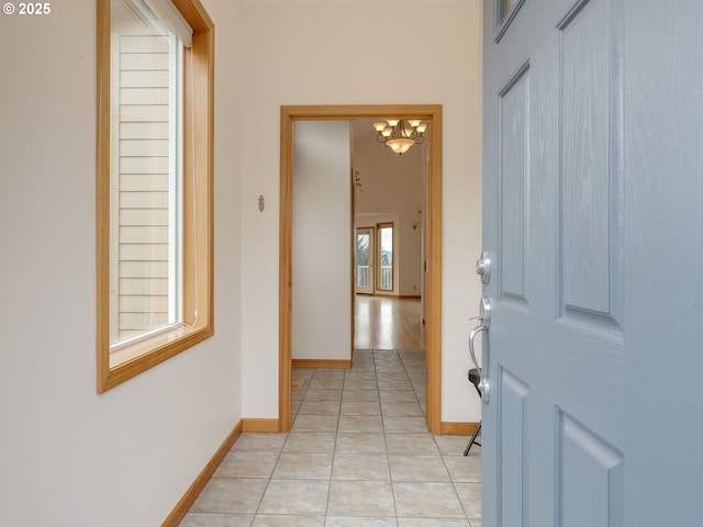 interior space with light tile patterned floors and baseboards