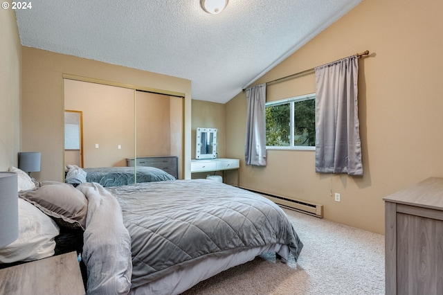 carpeted bedroom with a textured ceiling, baseboard heating, a closet, and lofted ceiling