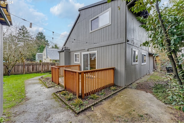 back of property with a wooden deck