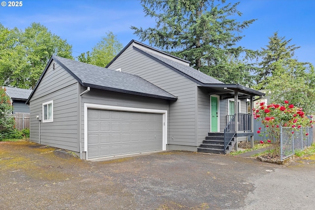 8941 SE Knapp St, Portland, OR 97266 - view of front of property featuring a shingled roof, a garage, driveway, and fence