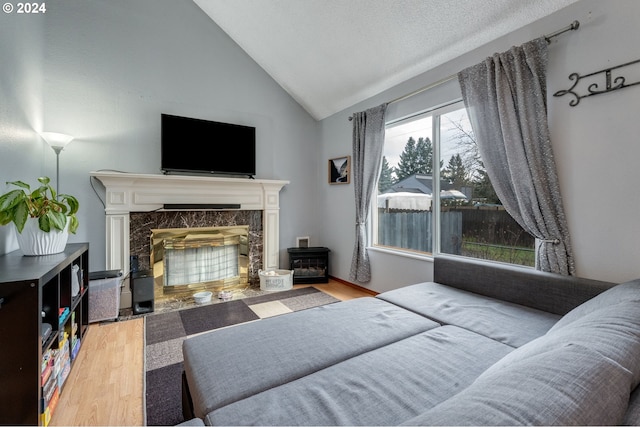 8941 SE Knapp St, Portland, OR 97266 - bedroom with wood finished floors, a fireplace, and vaulted ceiling