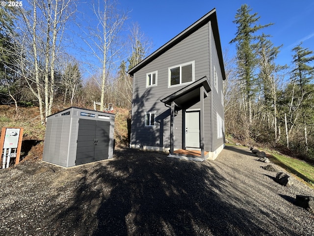 view of front of home featuring a storage unit