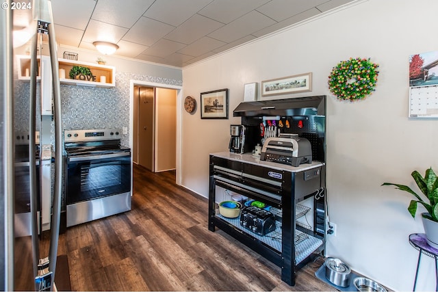 kitchen featuring appliances with stainless steel finishes, crown molding, and dark wood-type flooring