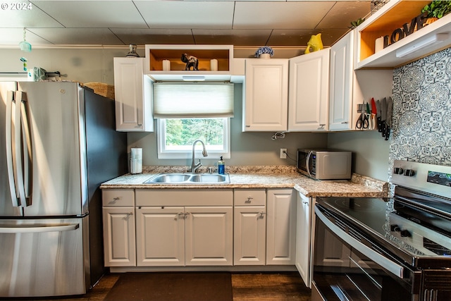 kitchen with white cabinetry, appliances with stainless steel finishes, and sink