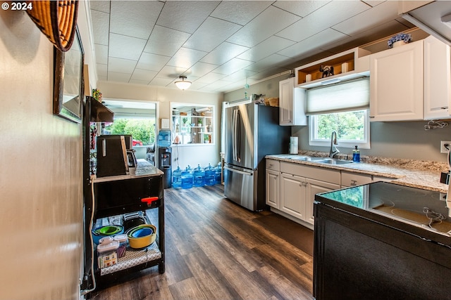 kitchen with stainless steel refrigerator, white cabinetry, sink, and dark hardwood / wood-style flooring