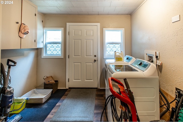 laundry area with cabinets, dark hardwood / wood-style flooring, independent washer and dryer, and crown molding